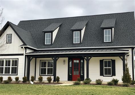 metal houses with brick|black shingles on brick house.